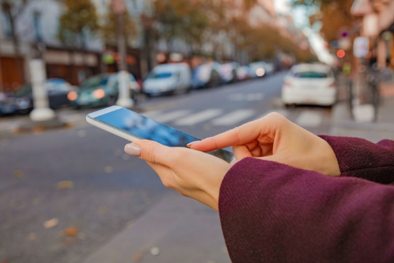 Pedestrian on their phone while crossing the street