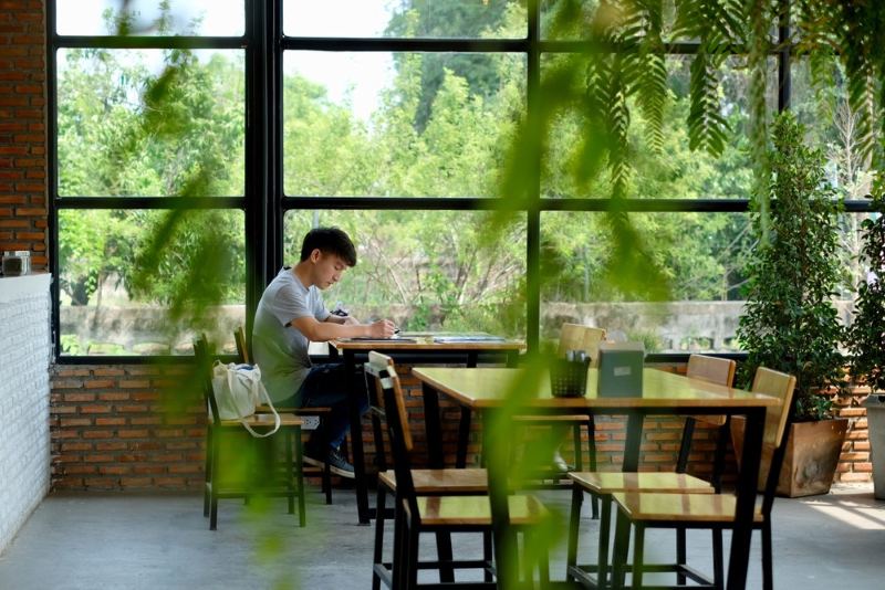 Young man sitting alone in a cafe restaurant